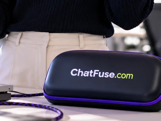A woman holding a phone and headset beside a case labeled ChatFuse.com